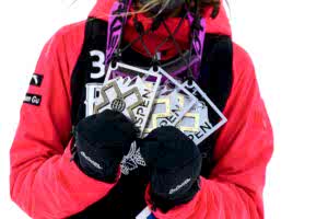 Winning athlete holding prizes