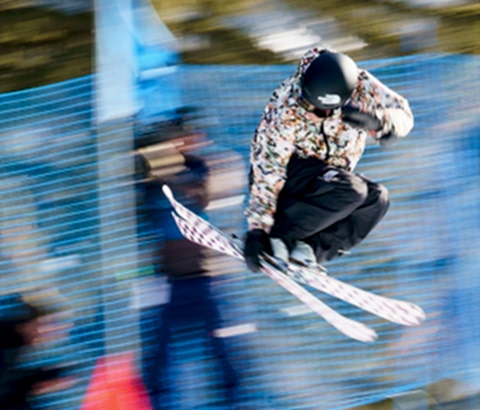 trick skier doing a grab trick over a ramp